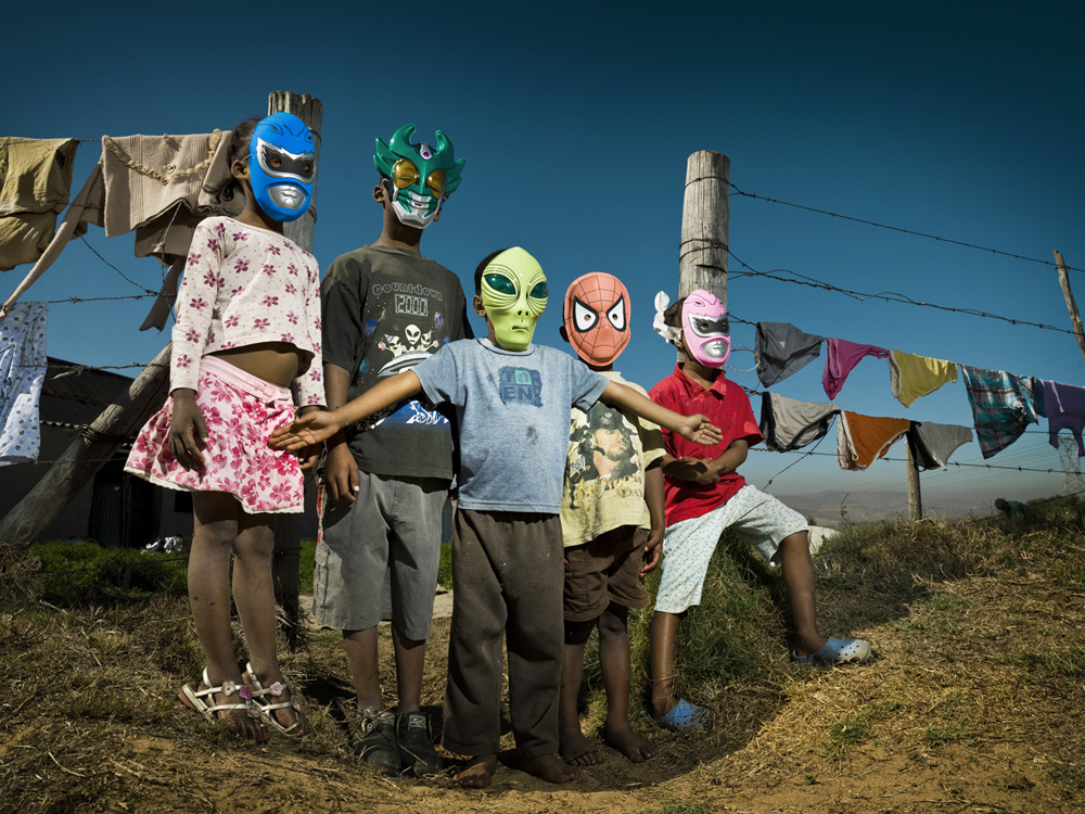 Native Kids in South Africa playing with masks in rural area.