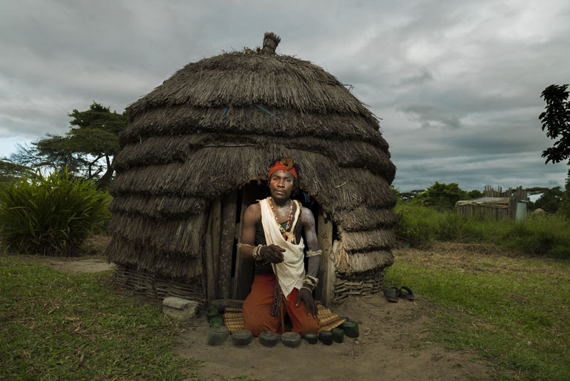 A Sangoma in in front of the healer's hut.
