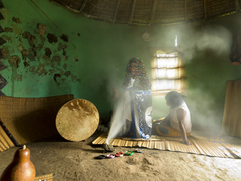 A Sangoma at a smoke ceremony in the healer's hut.