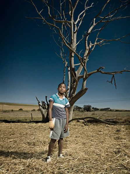 Native Kid in South Africa in front of death tree.