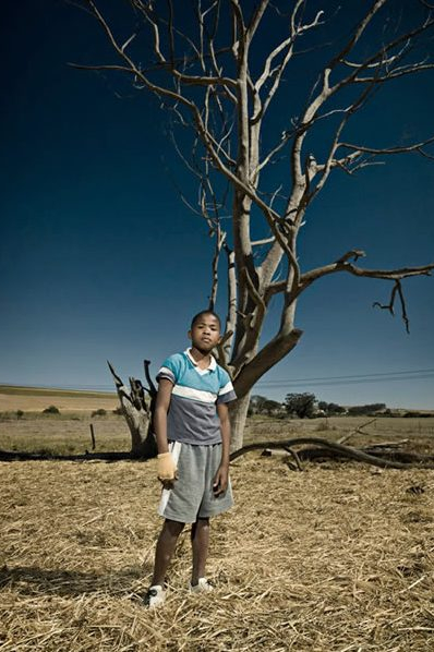 Young Southafrican kid alone in the field
